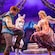 Rapunzel and Flynn sit in a boat and hold a lantern between them